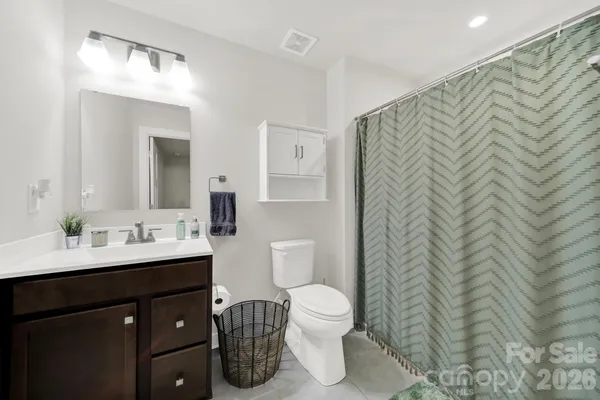 a bathroom with a sink toilet and mirror