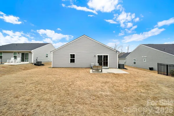a view of a house with backyard and a tree