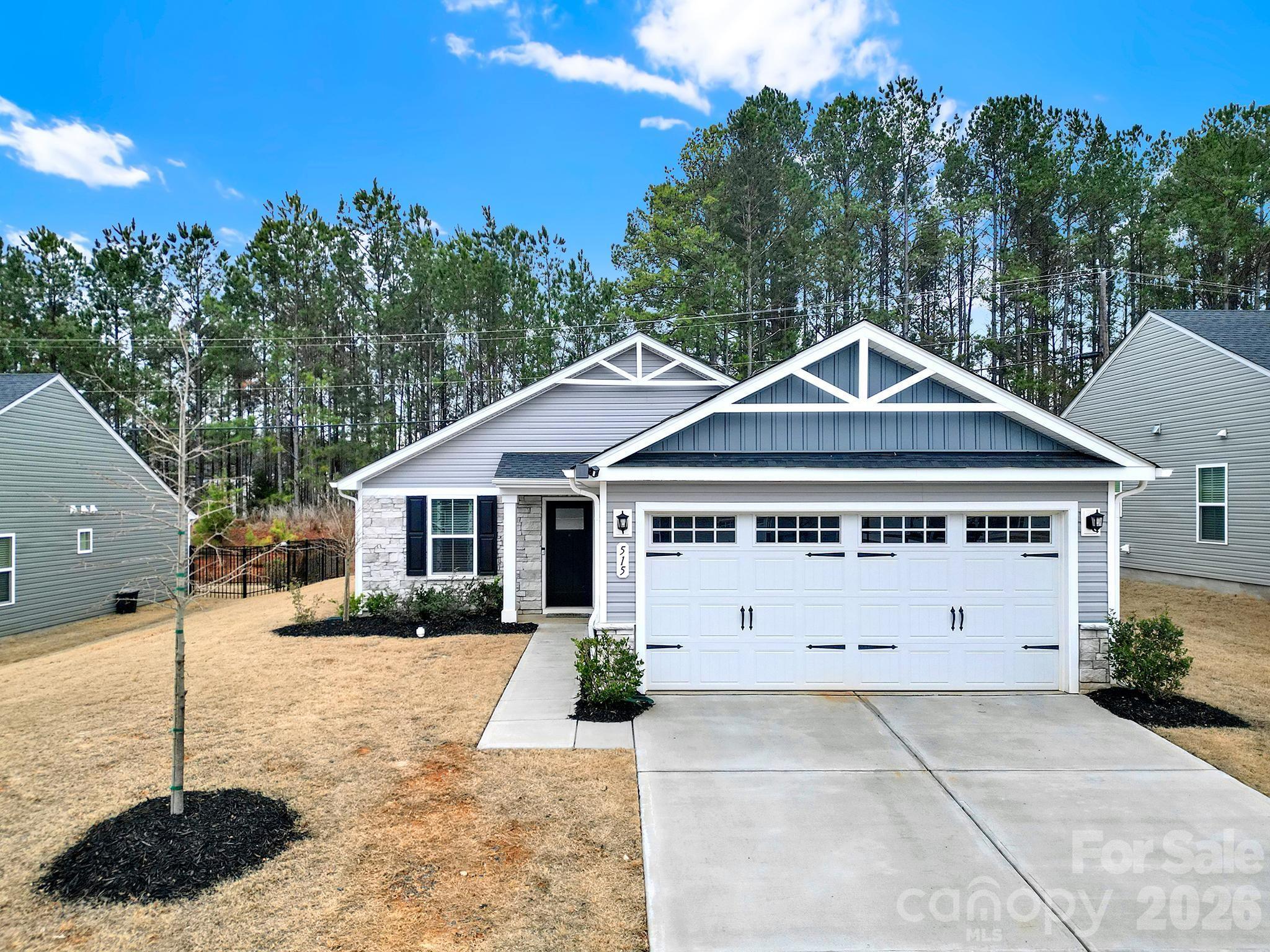 515 Grandiflora Avenue Lancaster, SC 29720 - Photo 3 of 29 a view of a white house with a yard