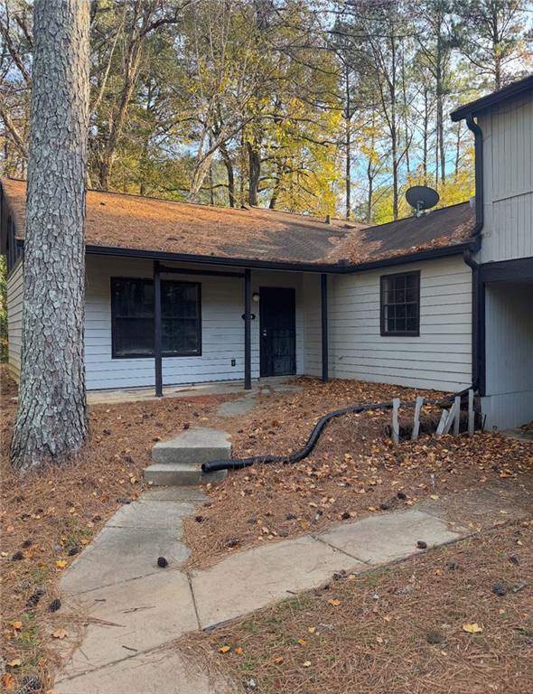 a front view of a house with a tree