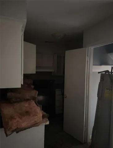 a kitchen with a refrigerator and a stove