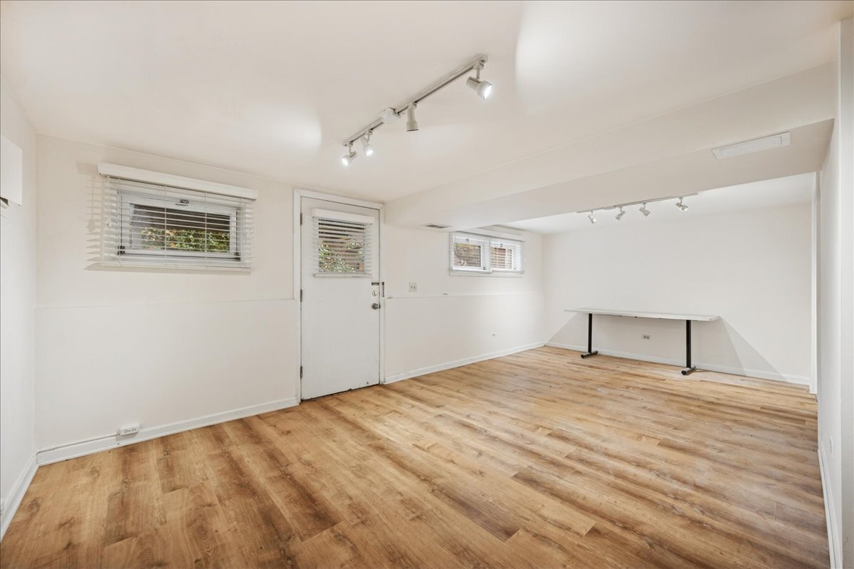 1918 Wilmette Avenue, Unit B Wilmette, IL 60091 - Photo 22 of 26 a view of an empty room with wooden floor and a window