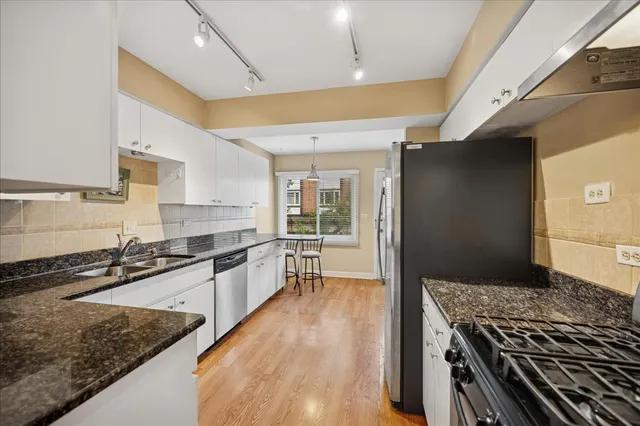 a kitchen with granite countertop a stove and a sink