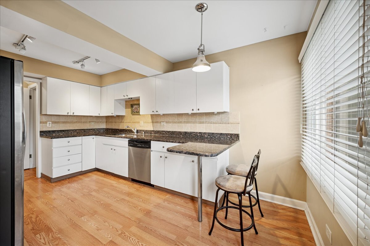 1918 Wilmette Avenue, Unit B Wilmette, IL 60091 - Photo 5 of 26 a kitchen with stainless steel appliances granite countertop a stove a sink and a refrigerator