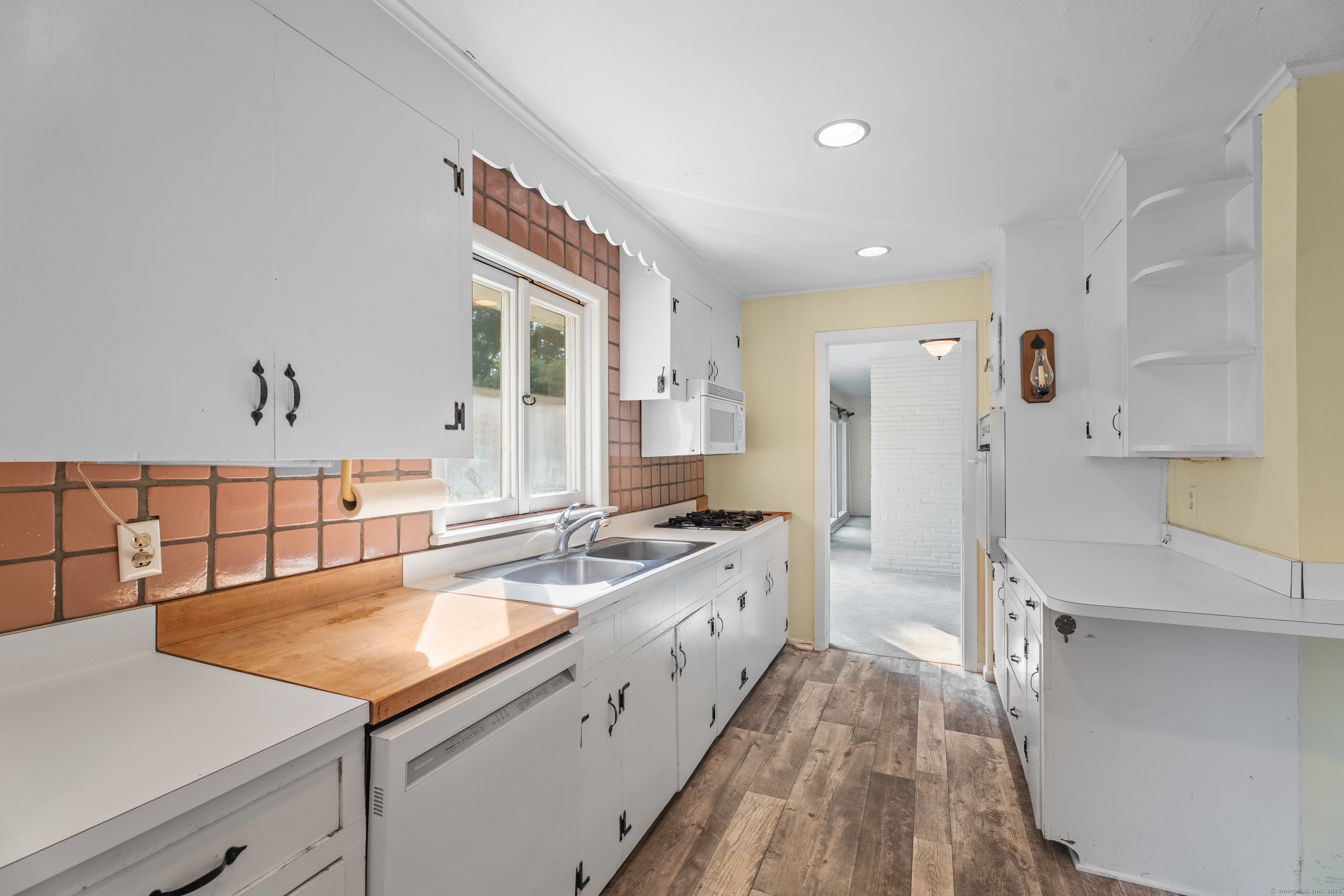 55 Harbor View Road Guilford, CT 06437 - Photo 14 of 38 a large kitchen with a sink and large window