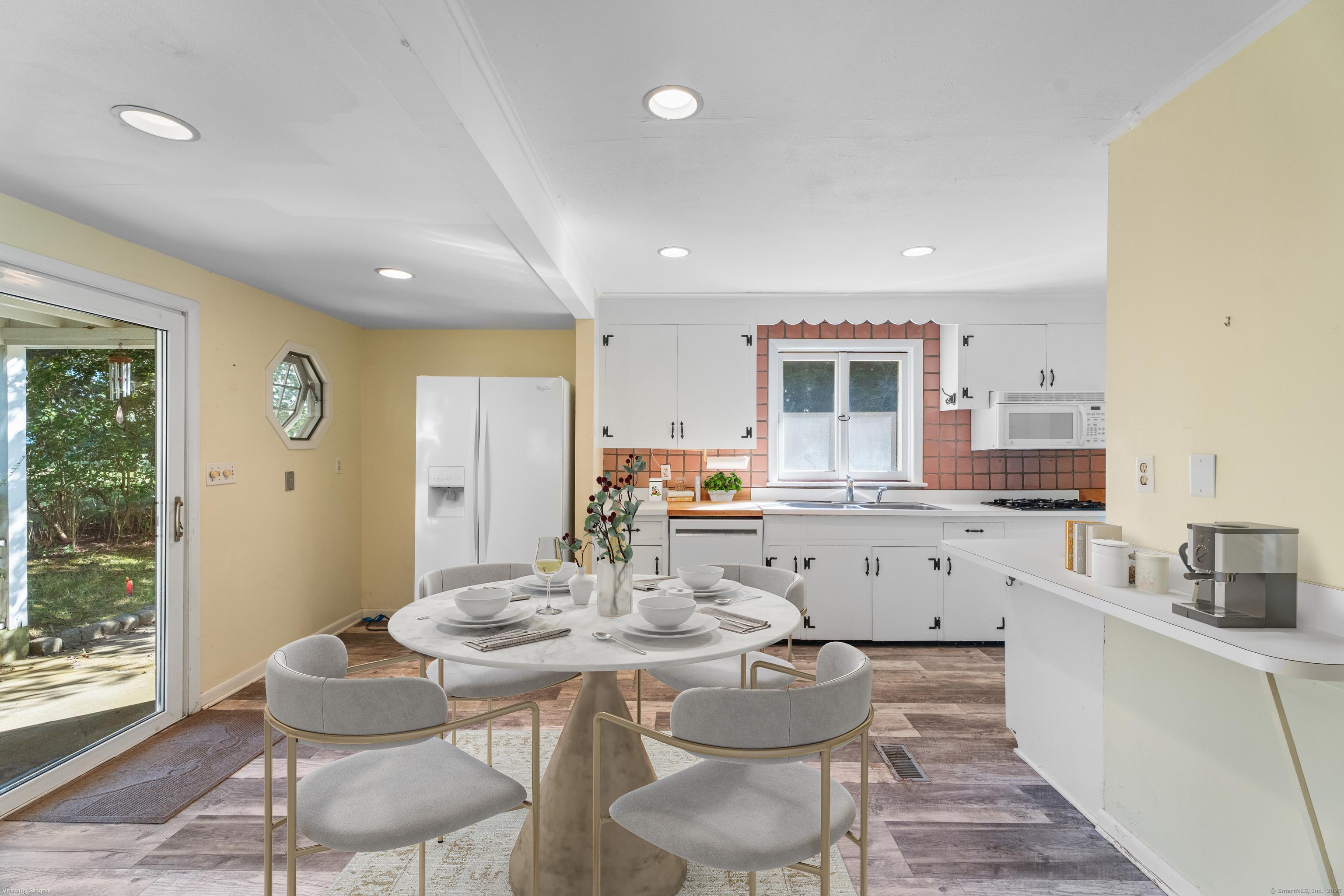 55 Harbor View Road Guilford, CT 06437 - Photo 4 of 38 a kitchen with a table and chairs in it