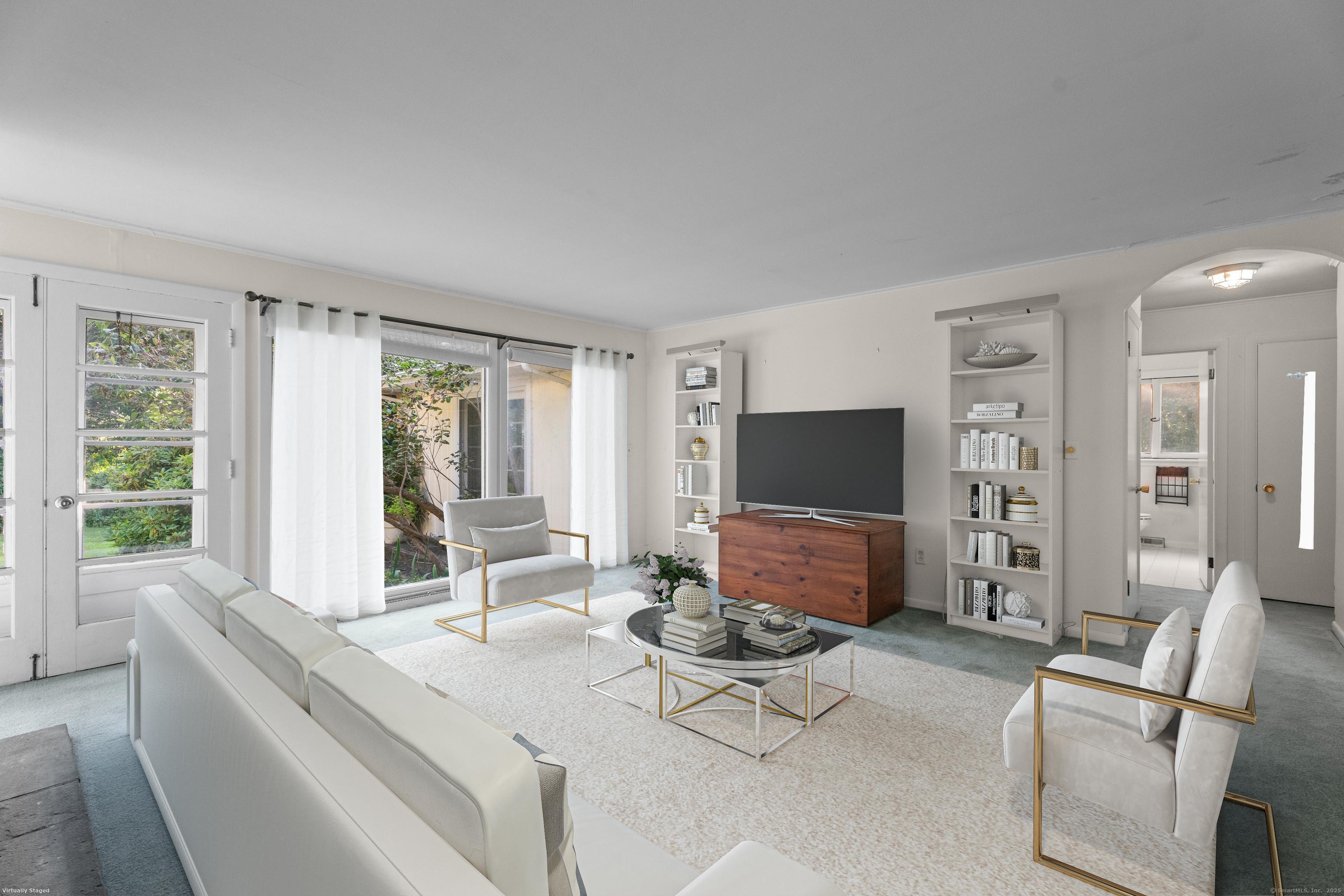 55 Harbor View Road Guilford, CT 06437 - Photo 6 of 38 a living room with furniture and a flat screen tv