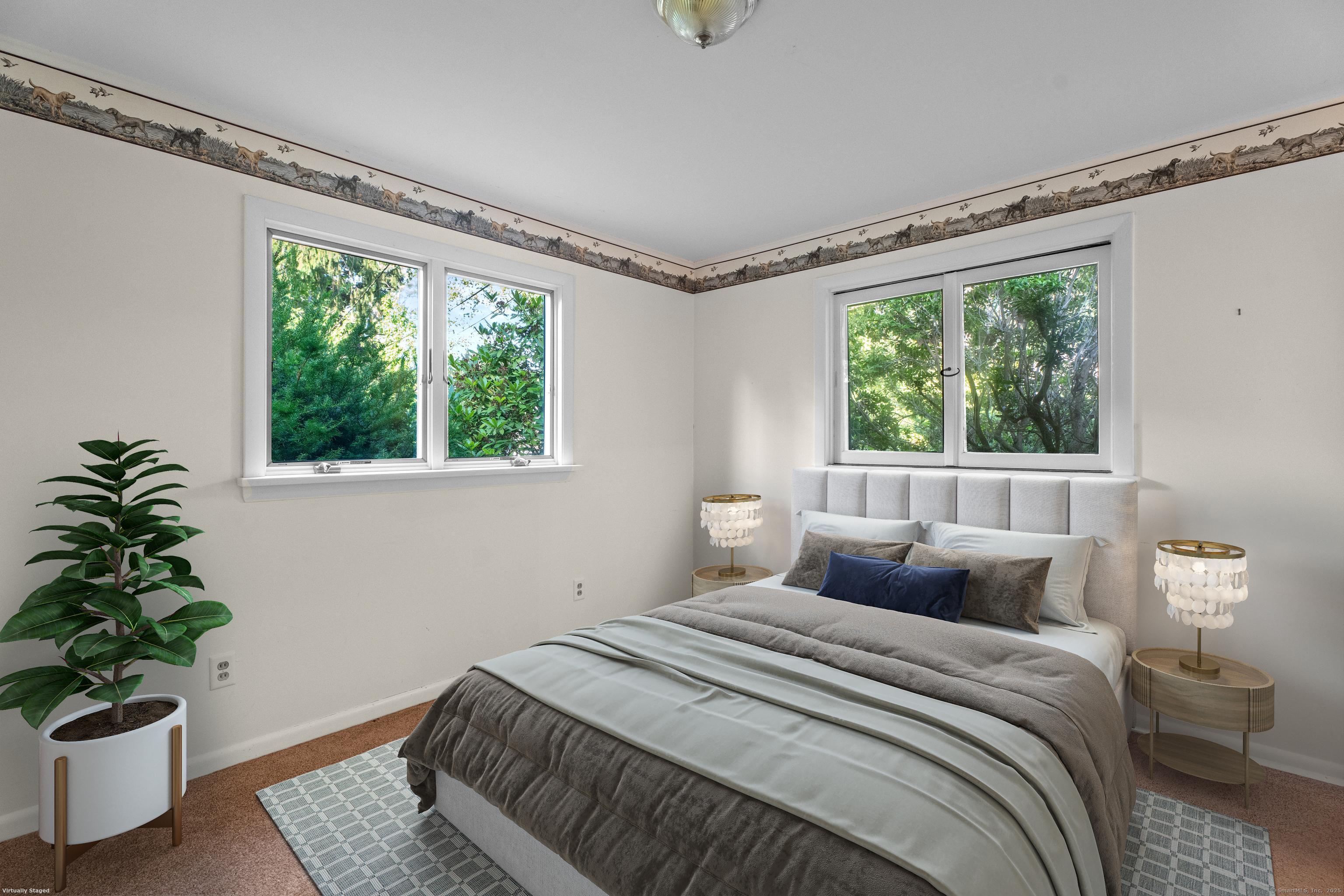 55 Harbor View Road Guilford, CT 06437 - Photo 8 of 38 a bedroom with a bed and a potted plant