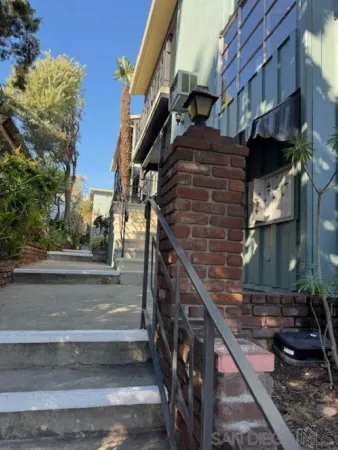 a view of street along with house and trees