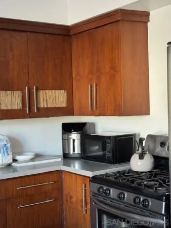 a kitchen with granite countertop a stove and a sink