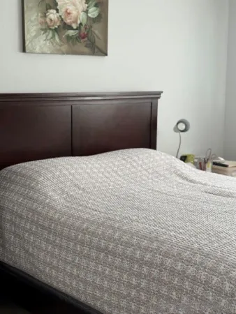 a bedroom with a bed and wall painting