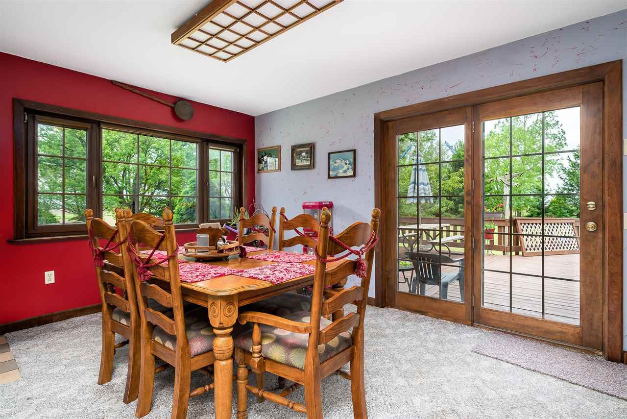 15666 East Bethel Road Rochelle, IL 61068 - Photo 16 of 22 a dining room with furniture and a floor to ceiling window