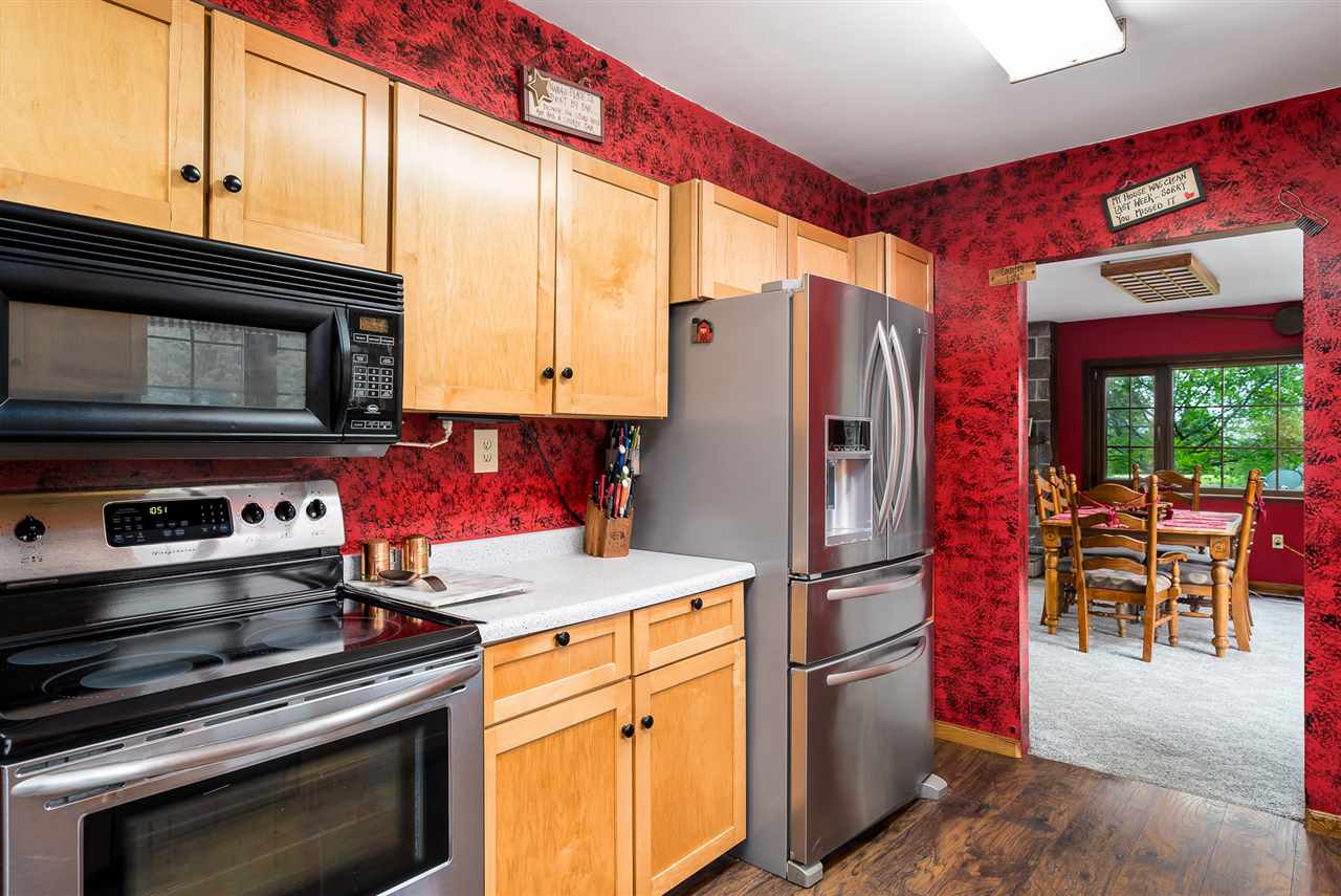 15666 East Bethel Road Rochelle, IL 61068 - Photo 19 of 22 a kitchen with stainless steel appliances granite countertop a refrigerator stove and microwave