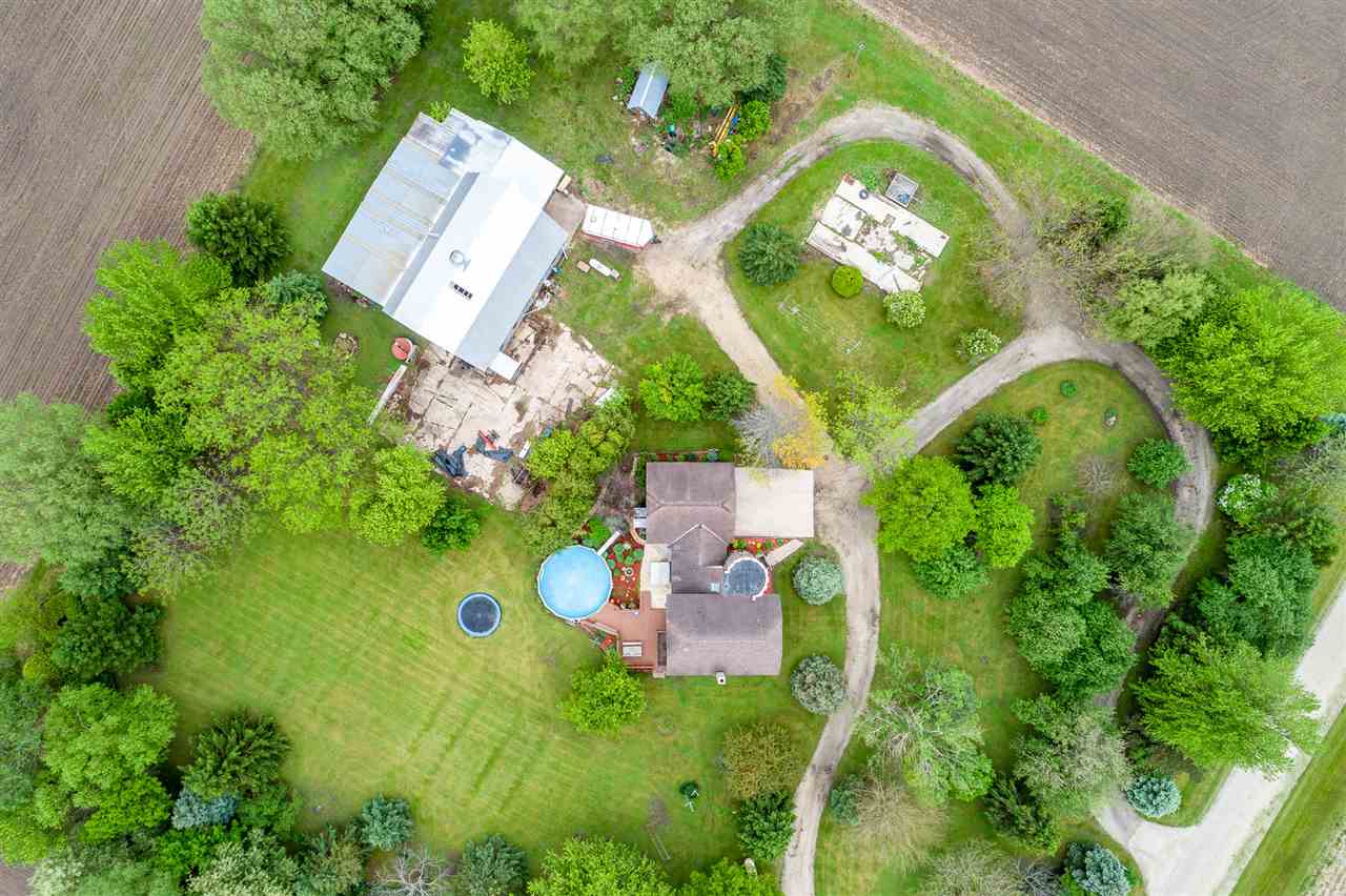 15666 East Bethel Road Rochelle, IL 61068 - Photo 3 of 22 an aerial view of a house with swimming pool and garden