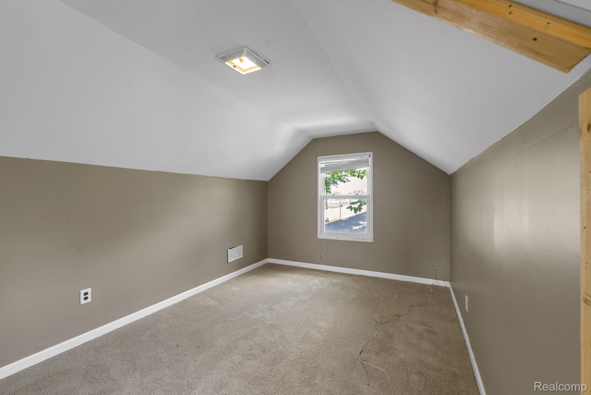 7641 Pelham Road Allen Park, MI 48101 - Photo 14 of 21 Carpeted room featuring sloped ceilings, a single window, and a square ceiling light fixture