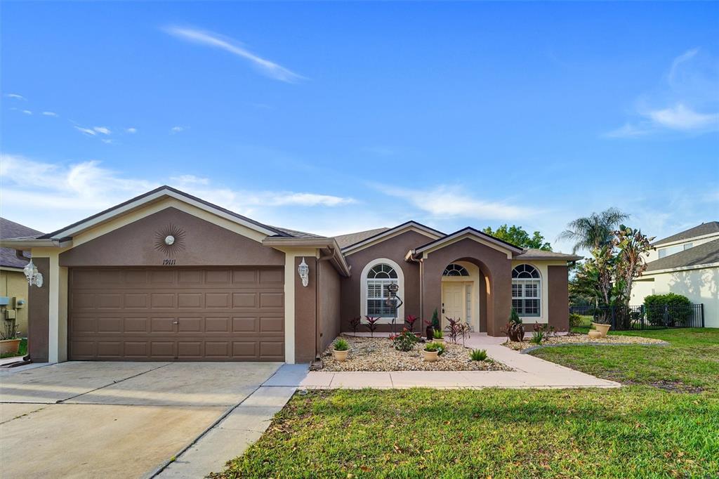 19111 Fern Meadow Loop Lutz, FL 33558 - Photo 11 of 41 a front view of a house with garden