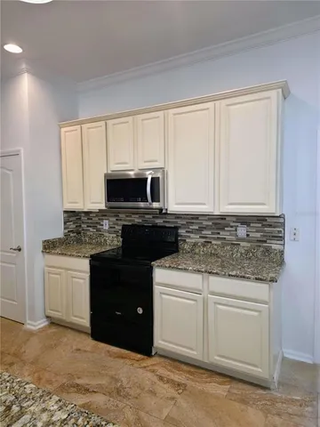 a kitchen with a sink stove and microwave