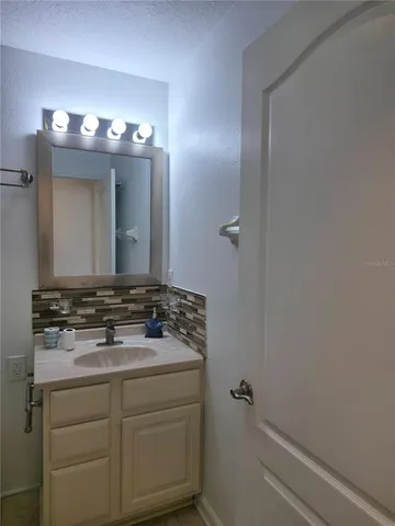 a bathroom with a sink and a mirror