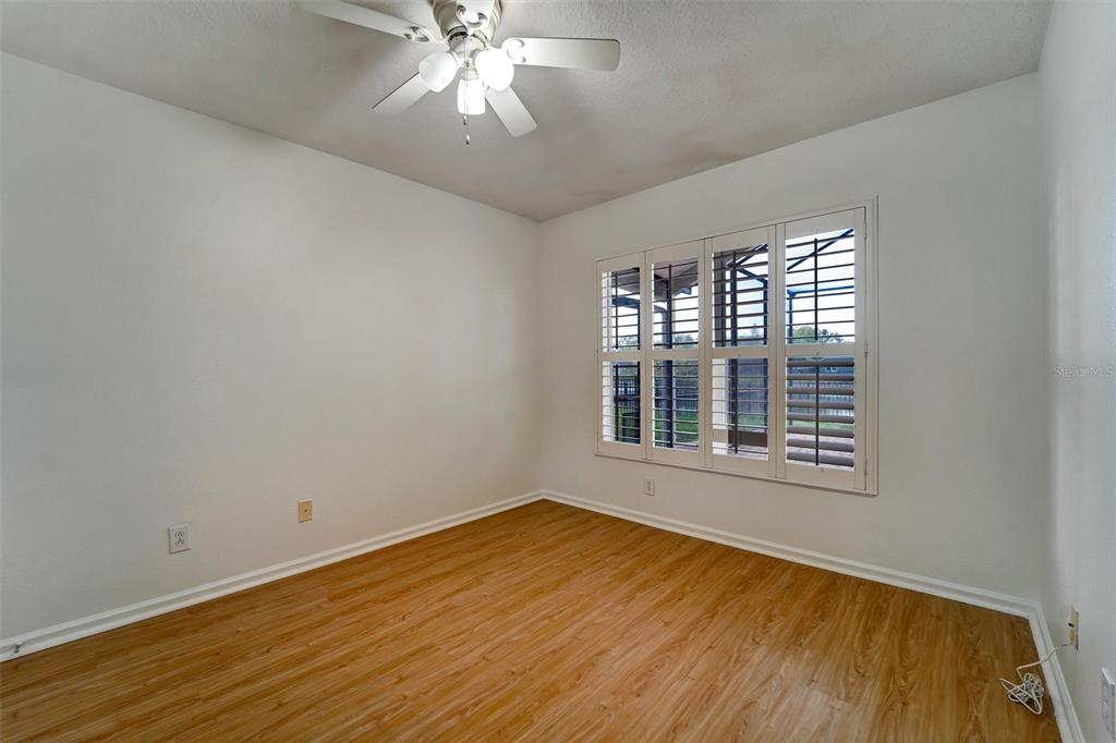 19111 Fern Meadow Loop Lutz, FL 33558 - Photo 18 of 41 a view of an empty room with wooden floor and a window