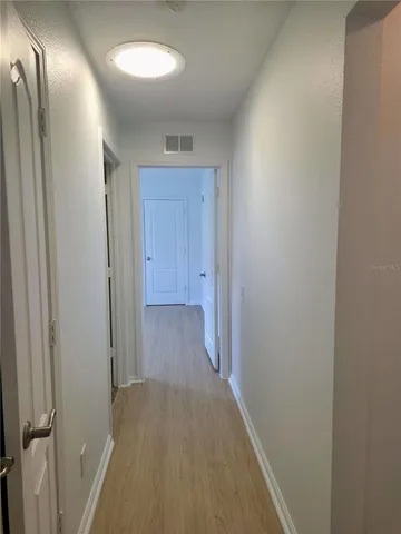 a view of hallway with wooden floor