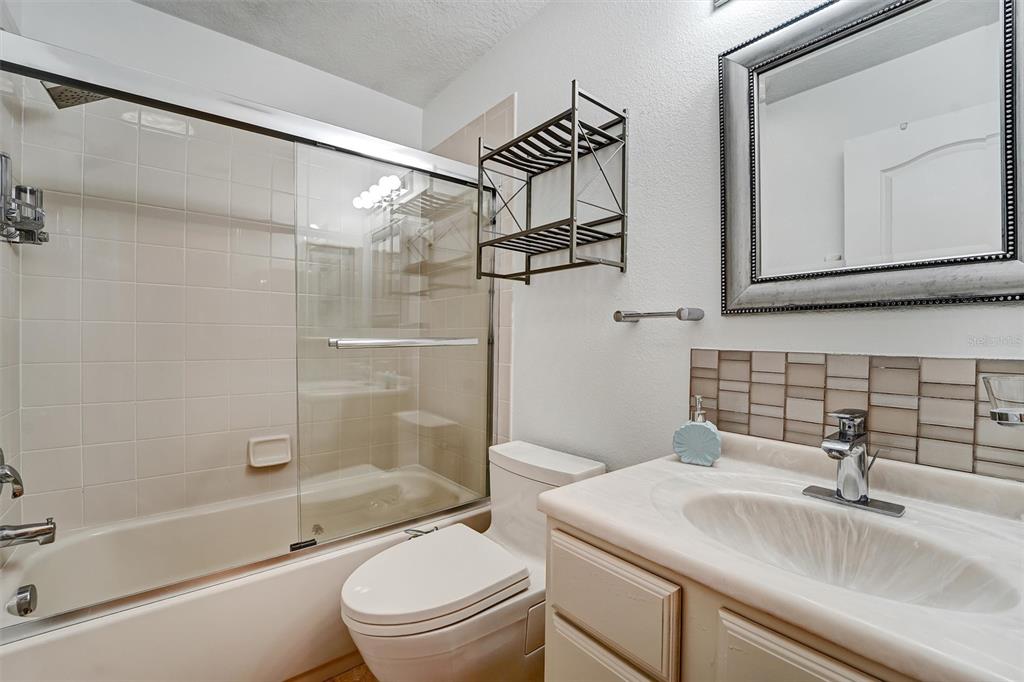 19111 Fern Meadow Loop Lutz, FL 33558 - Photo 19 of 41 a bathroom with a granite countertop sink toilet and shower