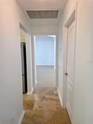 view of a hallway with wooden shelves