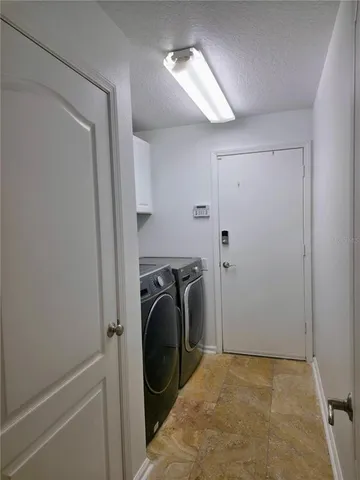 a view of a storage & utility room with a washer dryer