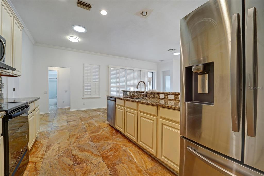 19111 Fern Meadow Loop Lutz, FL 33558 - Photo 26 of 41 a kitchen with stainless steel appliances granite countertop a refrigerator and a stove