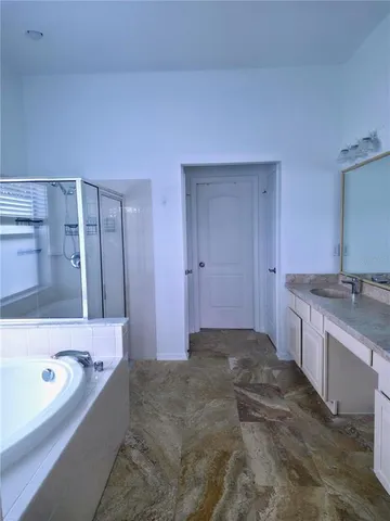 a bathroom with a tub and a window