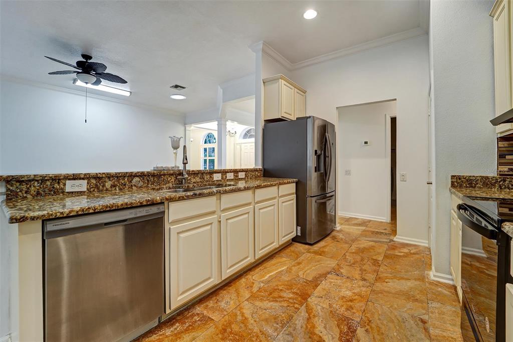 19111 Fern Meadow Loop Lutz, FL 33558 - Photo 28 of 41 a kitchen with stainless steel appliances granite countertop a refrigerator a stove and a sink