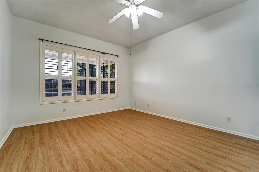 19111 Fern Meadow Loop Lutz, FL 33558 - Photo 35 of 41 a view of an empty room with wooden floor and a window