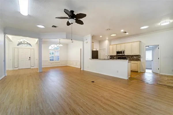 a view of kitchen with cabinets appliances and wooden floor