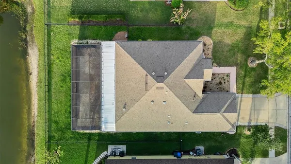 an aerial view of a house with a yard