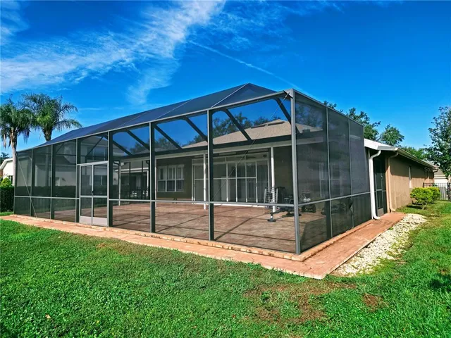 a view of house with backyard