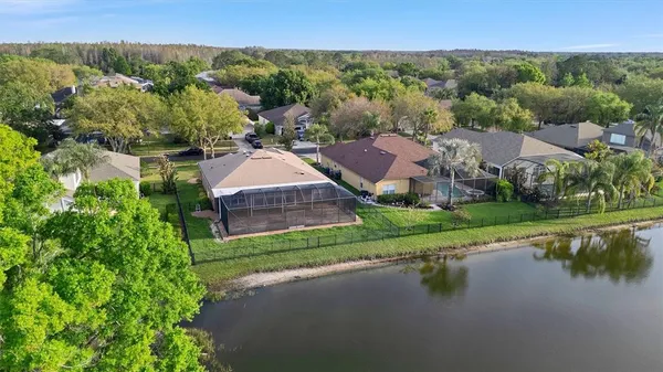an aerial view of a house with a garden and lake view