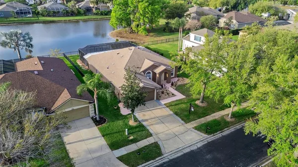 an aerial view of a house with a yard and outdoor seating