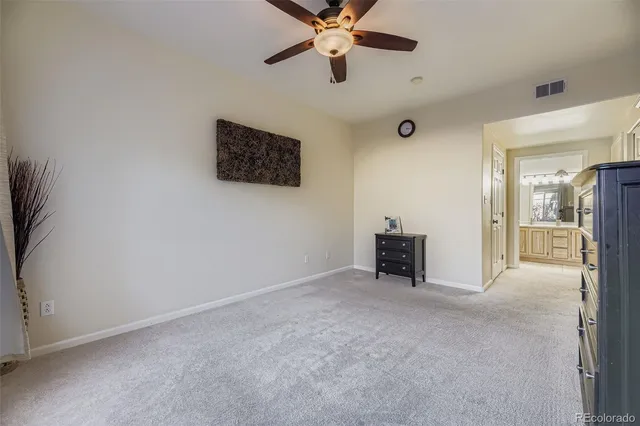 a view of an empty room with a ceiling fan