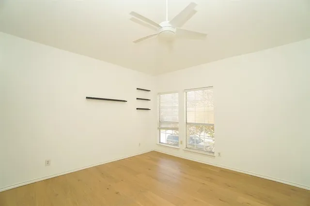 an empty room with windows and entrance