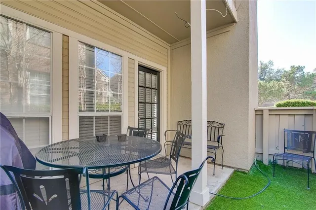 a view of balcony with a table and chairs