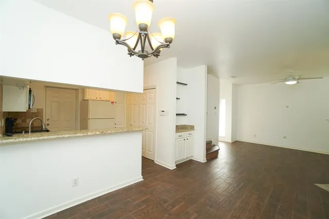 a view of a kitchen with a sink stainless steel appliances and cabinets