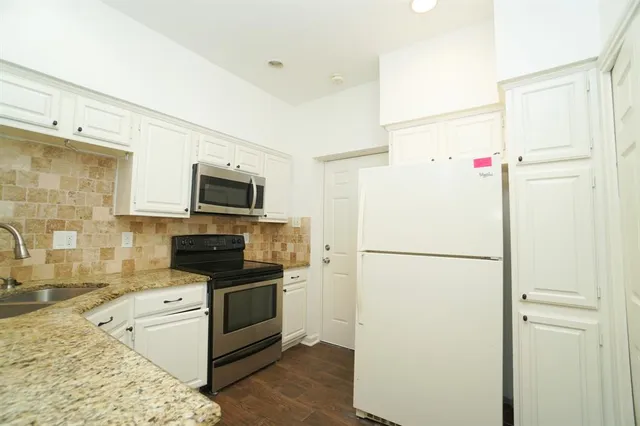 a white refrigerator freezer sitting inside of a kitchen