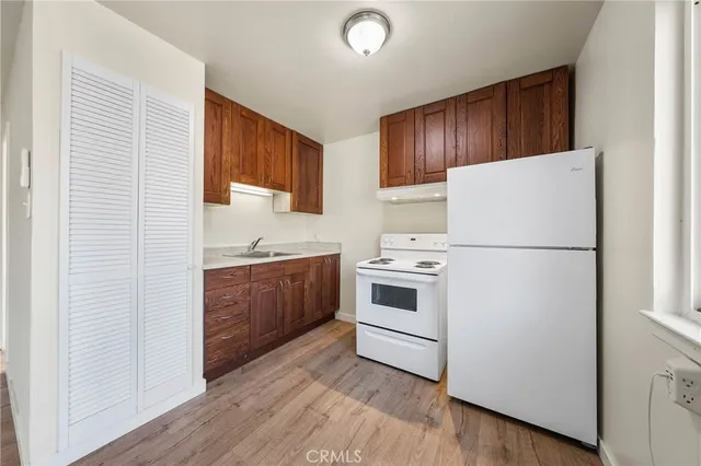 a kitchen with a refrigerator sink stove and cabinets