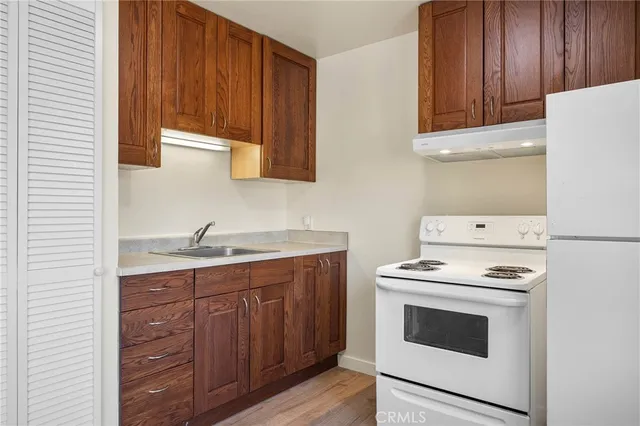 a kitchen with sink cabinets and appliances