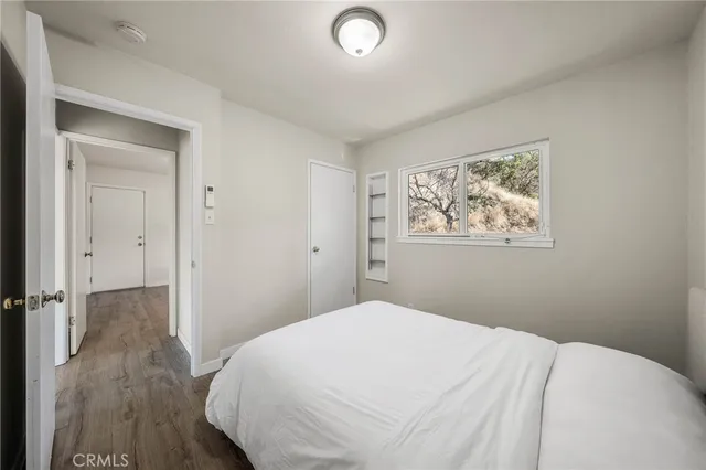 a bedroom with a bed and a painting on the wall