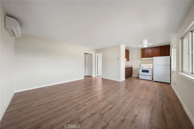 a view of a kitchen with a sink and a refrigerator