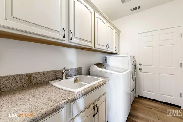 a utility room with sink dryer and washer