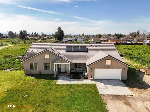 a aerial view of a house with swimming pool and a garden