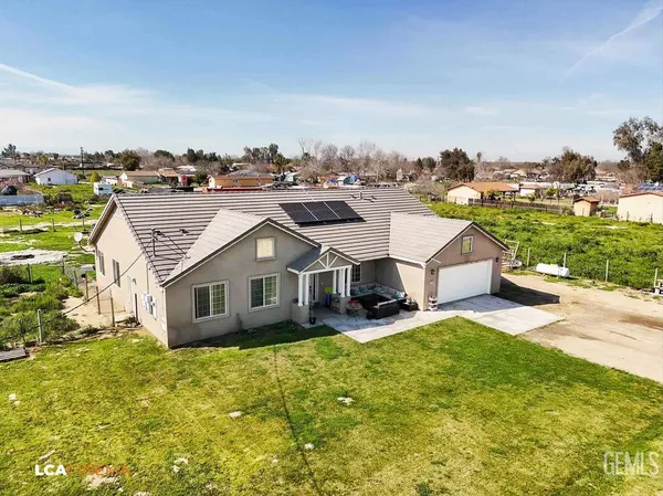 an aerial view of a house with a garden and trees