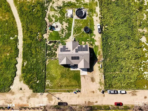 an aerial view of a house with a yard