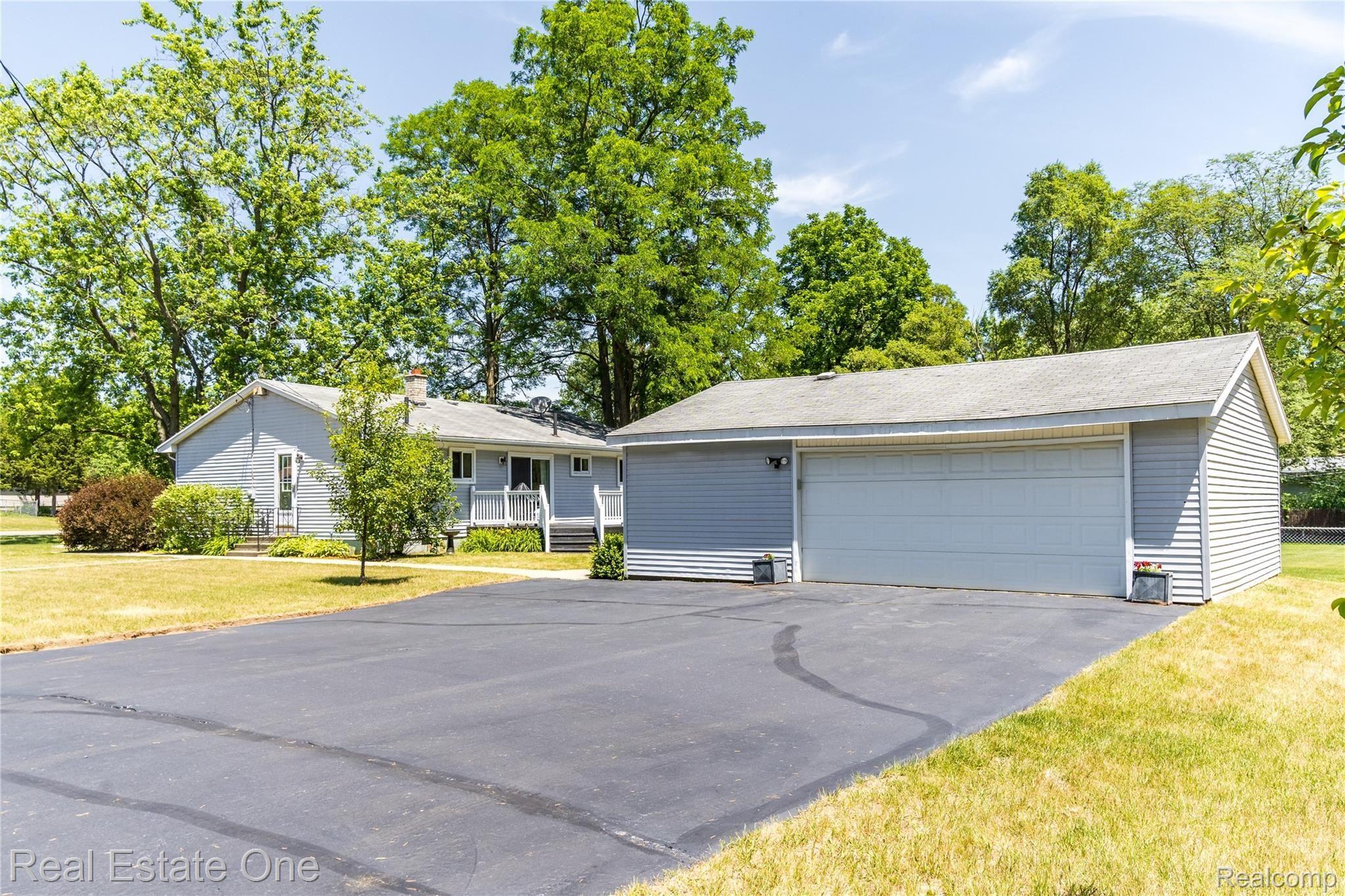 5131 Maybee Road Clarkston, MI 48346 - Photo 28 of 29 2.5 car garage offers lots of room for the hobbiest, electricity & door opener